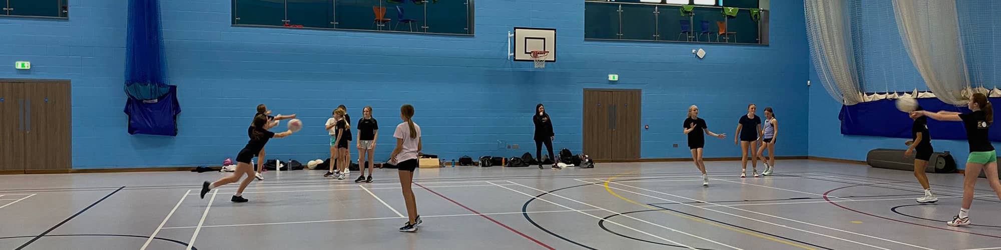 Netball lesson in Northwich sports hall